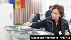 A woman casts her vote at a polling station in Chisinau on September 28.