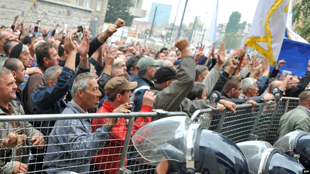 Police try to prevent angry protesters - mainly war veterans - from storming the federal parliament building. 