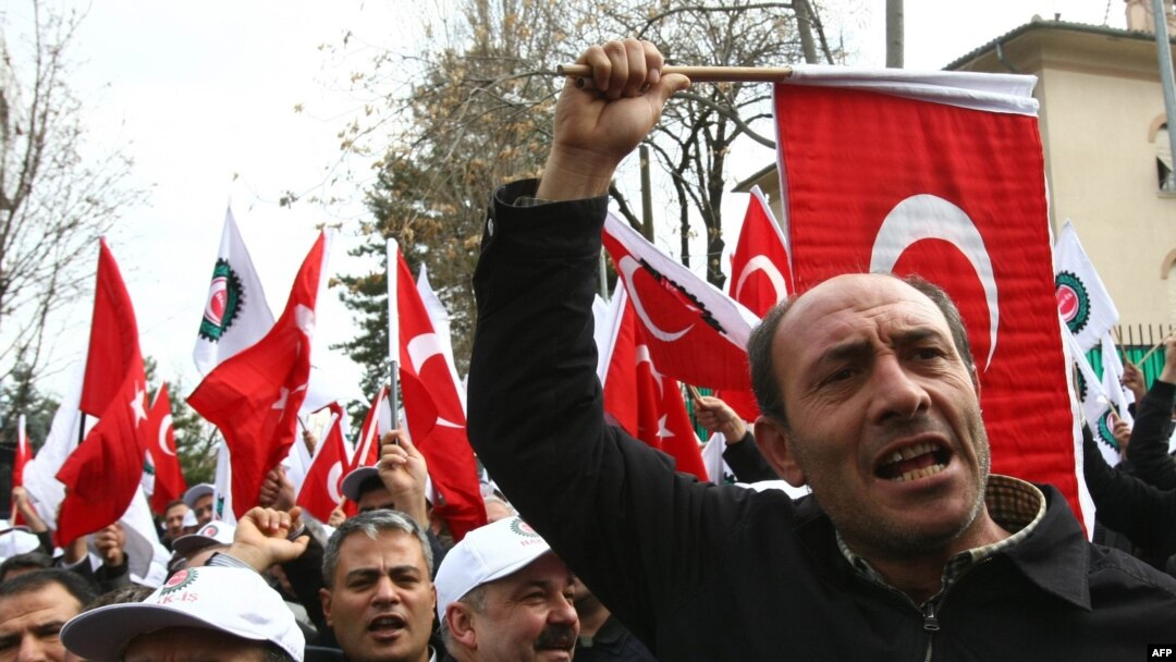 Turks protest outside the French Embassy in Ankara after a controversial Armenian genocide bill was passed by the lower house of parliament in Paris.