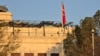 The flag of Turkey hangs from a pole at the embassy in Damascus.