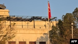 The flag of Turkey hangs from a pole at the embassy in Damascus.