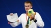 Indonesia-Swimming - 2018 Asian Games - Men's 100m Breaststroke Final - GBK Aquatic Center, Jakarta, Indonesia - August 22, 2018 Bronze medalist Dmitriy Balandin of Kazakhstan during the medal ceremony REUTERS/Athit Perawongmetha