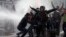 Azerbaijani police use water cannons to break up a crowd of protesters during a rally in Baku in March.