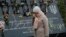 A woman pays respects at a memorial for people killed in clashes with security forces six years ago in Kyiv. 