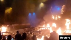 Protesters in Tehran gather as vehicles burn amid anti-government unrest in Iran.