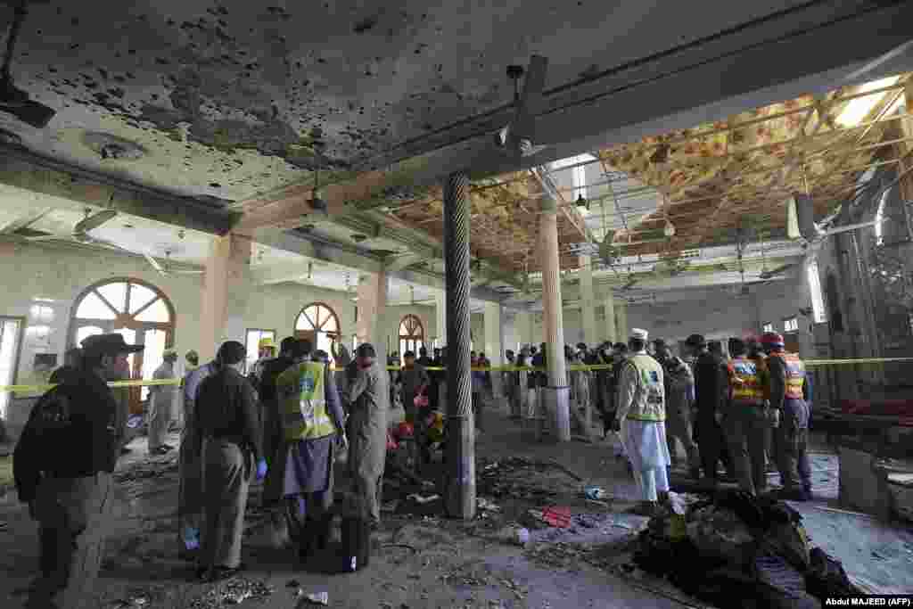 Security officials examine the site of the blast.