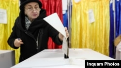 A woman casts her vote for the Senate in Bucharest on December 1.