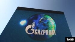 The Gazprom logo rises above the site in Shakai of the first joint of a Minsk-Vilnius-Kaunas-Kaliningrad gas pipeline in 2009.