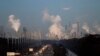 A supermoon, undergoes an eclipse as it sets beyond gas refineries, at sunrise in St. Charles Parish, La., Wednesday, Jan. 31, 2018.