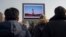 North Koreans in Pyongyang watch a public broadcast of a previous missile launch. (file photo)