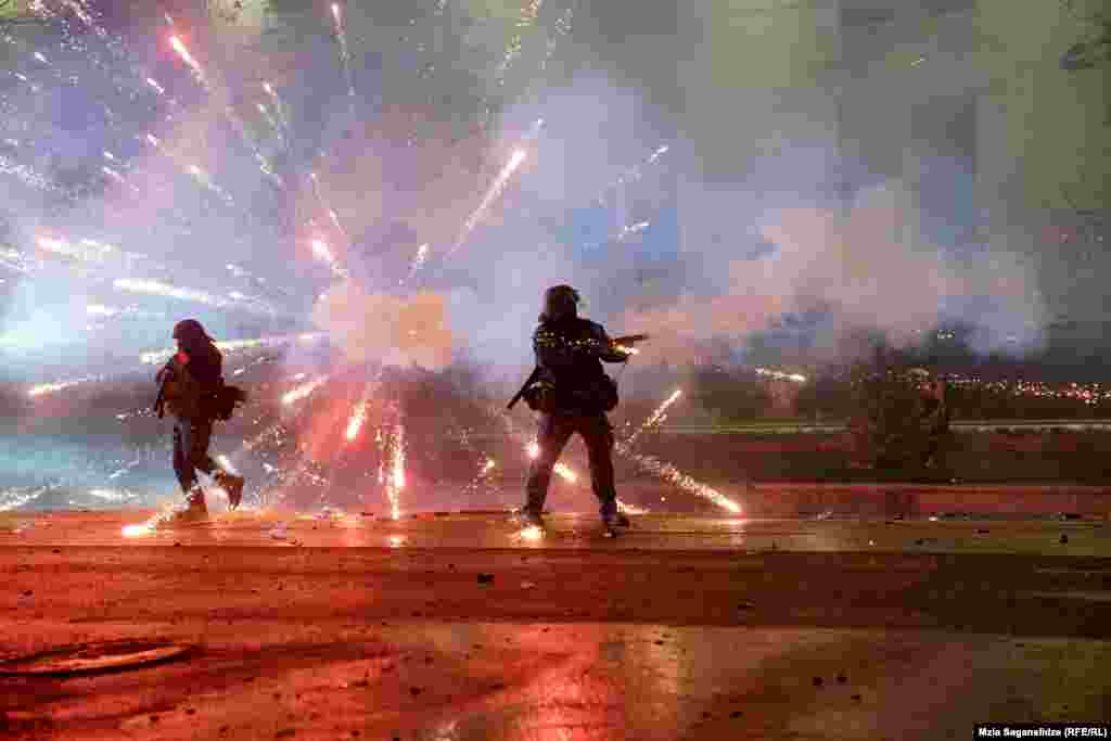 A firework explodes amid clashes between police and opposition protesters in the Georgian capital, Tbilisi.&nbsp;