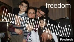 Armenia - Nerses Poghosian poses for a photograph with his wife and children.