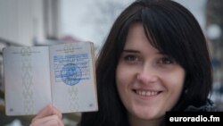 Anastasia Palazhanka brandishes her passport in an undated photo.