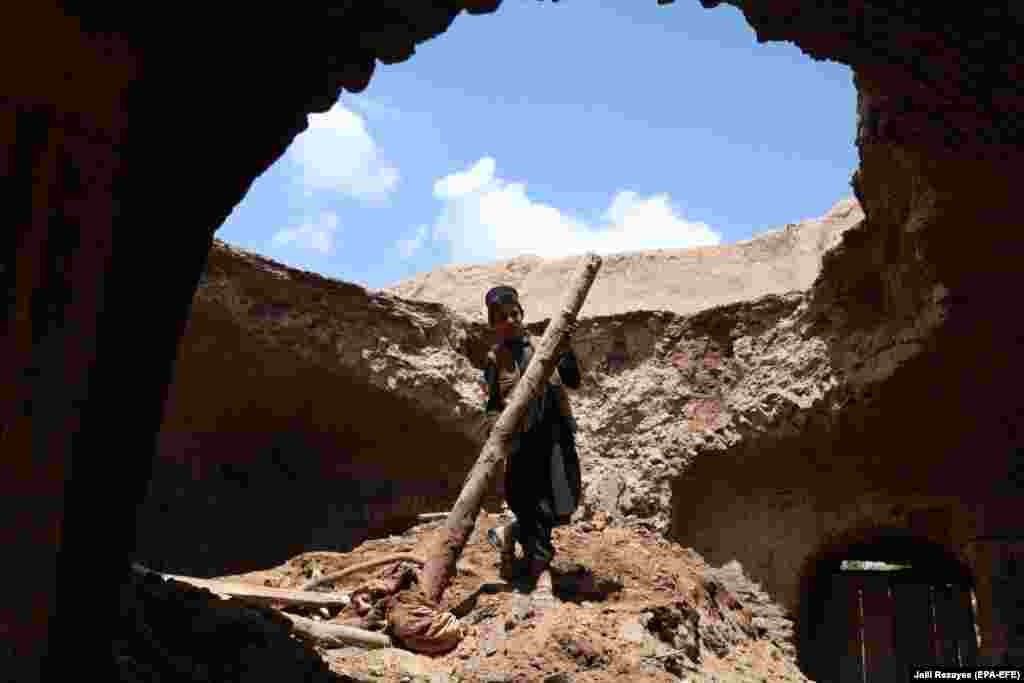 A boy surveys damage to a house that was hit by flash floods in the village of Ziaratjah in Afghanistan&#39;s Herat Province. (epa-EFA/Jalil Rezayee)