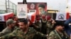 Members of the Popular Mobilization Forces carry the remains of fighters killed in suspected US air strikes in Baghdad in April. 