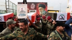 Members of the Popular Mobilization Forces carry the remains of fighters killed in suspected US air strikes in Baghdad in April. 