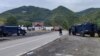 Kosovo -- Kosovo police officers patrol by trucks where Kosovo Serbs block a road near the northern Kosovo border crossing of Jarinje, September 21, 2021.