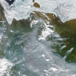 A satellite image shows smoke from active fires burning near Verkhoyansk on June 23