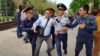 Полицейские задерживают человека, находившегося на месте, которое запрещенное в стране движение обозначило как площадку для проведения митинга. Алматы, 10 мая 2018 года.