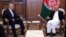 Afghan President Ashraf Ghani (right) meets with U.S. envoy Zalmay Khalilzad in Kabul in July.