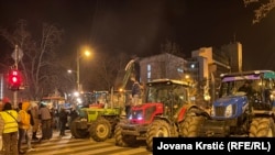 Students and others, some on tractors, block a bridge in Novi Sad, Serbia, on February 1.