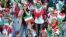 Iranian women cheer ahead of the World Cup Qatar 2022 Group C qualification football match between Iran and Cambodia at the Azadi stadium in the capital Tehran on October 10, 2019.