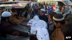 Relatives and volunteers move the body of a convicted militant from the banned Sunni militant group Lashkar-e-Jhangvi (LeJ) from the central jail in Karachi to an ambulance after he was executed in early February, more than a month after Pakistan's unofficial moratorium on capital punishment was lifted.