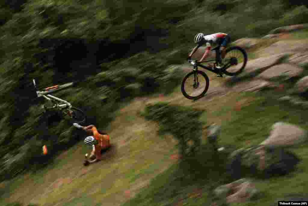 Mathieu van der Poel of the Netherlands tumbles on a downhill during the men&#39;s cross country mountain bike competition at the 2020 Summer Olympics, Monday, July 26, 2021, in Izu, Japan.&nbsp;