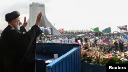 Iranian President Ebrahim Raisi waves during a ceremony marking the 44th anniversary of the Islamic Revolution in Tehran on February 11.