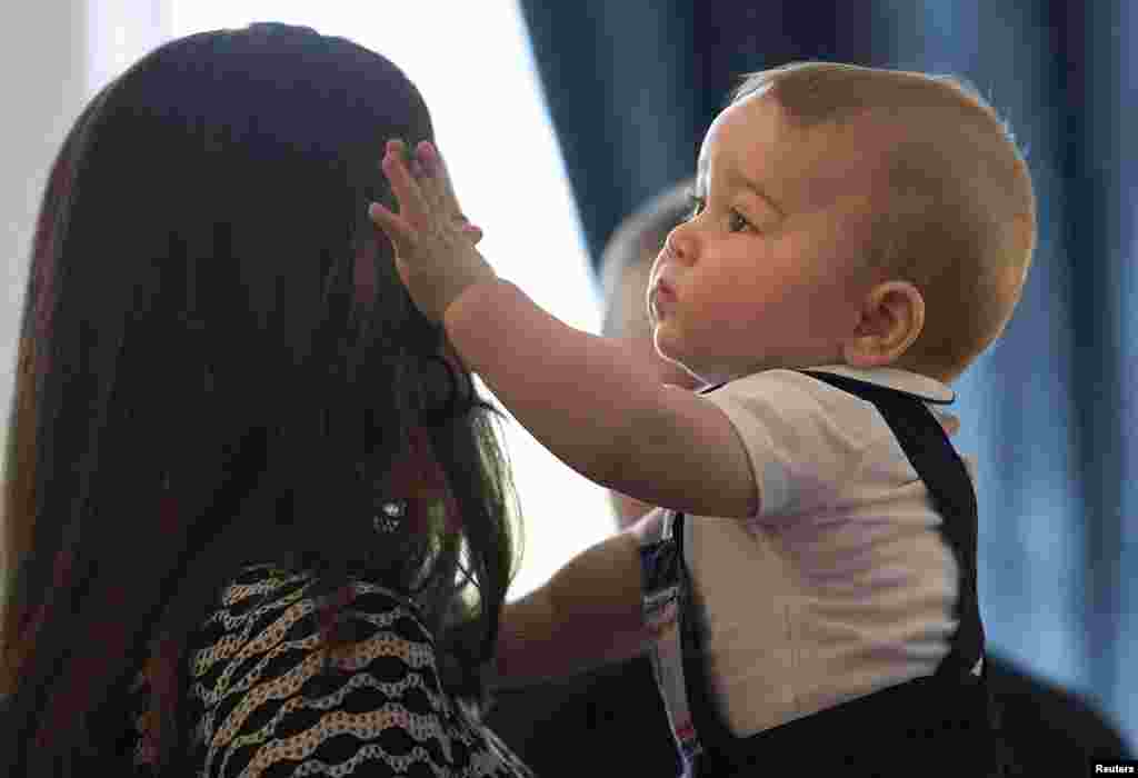 New Zealand - Catherine, Duchess of Cambridge, holds her son Prince George during a Plunket nurse and parents' group event at Government House in Wellington April 9, 2014