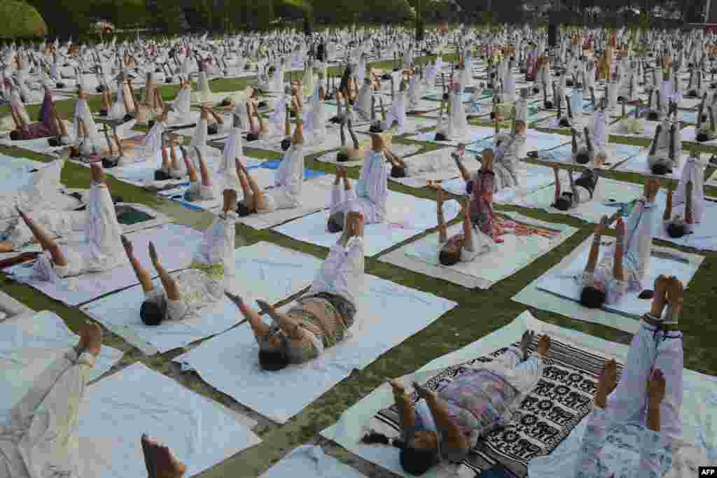 Indian yoga practitioners participate in a session organized by the Bharatiya Yog Sansthan Association on the outskirts of Amritsar. (AFP/Narinder Nanu)