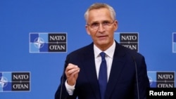 NATO Secretary-General Jens Stoltenberg talks to reporters in Brussels on October 11.