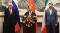 Russian Deputy Foreign Minister Sergei Ryabkov, Chinese Executive Vice Minister of Foreign Affairs Ma Zhaoxu, and Iranian Deputy Foreign Minister Kazem Gharibabadi pose after a meeting in Beijing on March 14. 