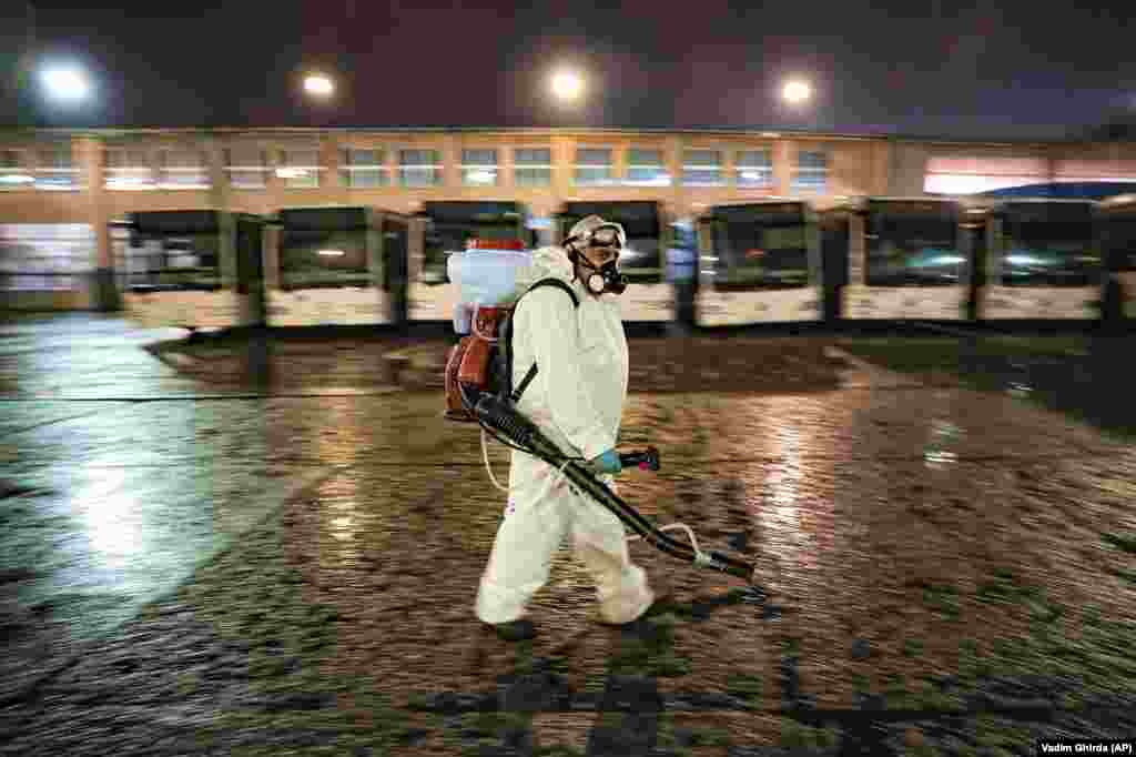 In Bucharest, Romania, a public-transport employee carries out the daily disinfection of buses, to help limit the spread of the coronavirus. (​AP/Vadim Ghirda) &nbsp; &nbsp;