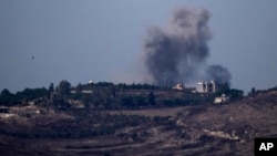 Smoke rises following an Israeli air strike in southern Lebanon as seen from northern Israel on September 30.