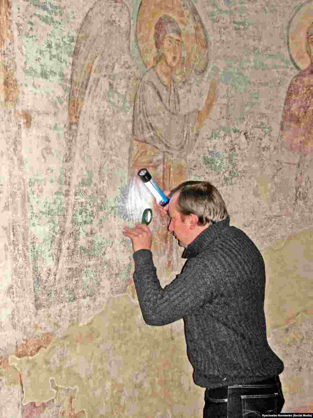 Kornienko studying old graffiti near the beginning of what would become a 15-year project. &nbsp; The historian says that &ldquo;people wrote graffiti for their contemporaries, but these records allow us to look at the world through the eyes of the people of that time.&rdquo;