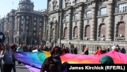 Gay-rights acivists march in a gay-pride parade in Belgrade on October 10. Mirojlub Petrovic says he can "cure" gays with his "original medicine."