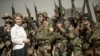 German Defense Minister Ursula von der Leyen (L) stands among Kurdish Peshmerga and German Bundeswehr soldiers during a visit to the educational centre Bnaslawa near Irbil, Septebmer 23, 2016 File photo