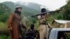 Tehrik-e Taliban (TTP) militants patrol an area in Shawal, in the Pakistani tribal region of South Waziristan, in August 2021. The Afghan Taliban's takeover of neighboring Afghanistan that month has emboldened the TTP to carry out more attacks within Pakistan. 