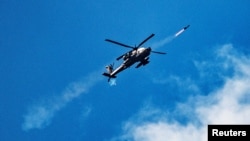 An Israeli attack helicopter fires towards Lebanon amid cross-border hostilities between Hezbollah and Israel, as seen from northern Israel on October 1.