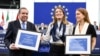 Venezuela's Edmundo Gonzalez Urrutia (left), European Parliament President Roberta Metsola (center), and Ana Corina Sosa, the daughter of Venezuelan politician Maria Corina Machado, pose for photographs in Strasbourg after Urrutia and Machado were awarded the Sakharov Prize in December 2024. 