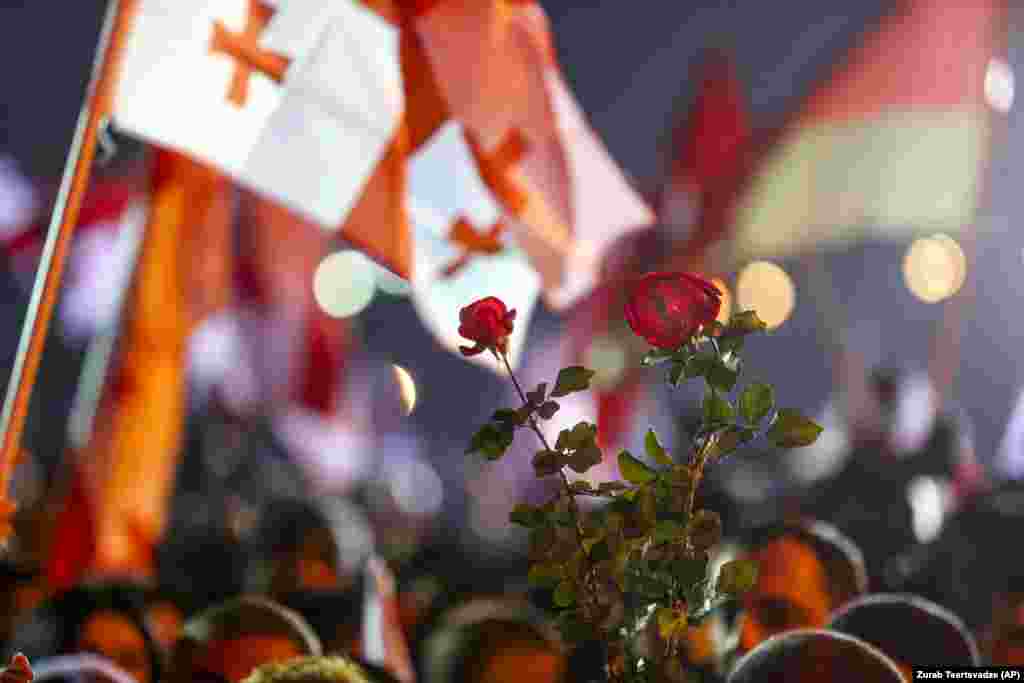 Georgian opposition supporters of former President Mikheil Saakashvili hold national flags and roses as a symbol of a revolution during a rally in front of the prison where he is being held, in Rustavi, about 20 kilometers from the capital, Tbilisi, on November 6.