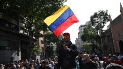 A supporter of President Nicolas Maduro holds a Venezuelan flag during a gathering near the Palacio de Miraflores in Caracas on January 3.