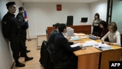 Court officials and lawyers attend the hearing of the Golos NGO in Moscow on April 25. 