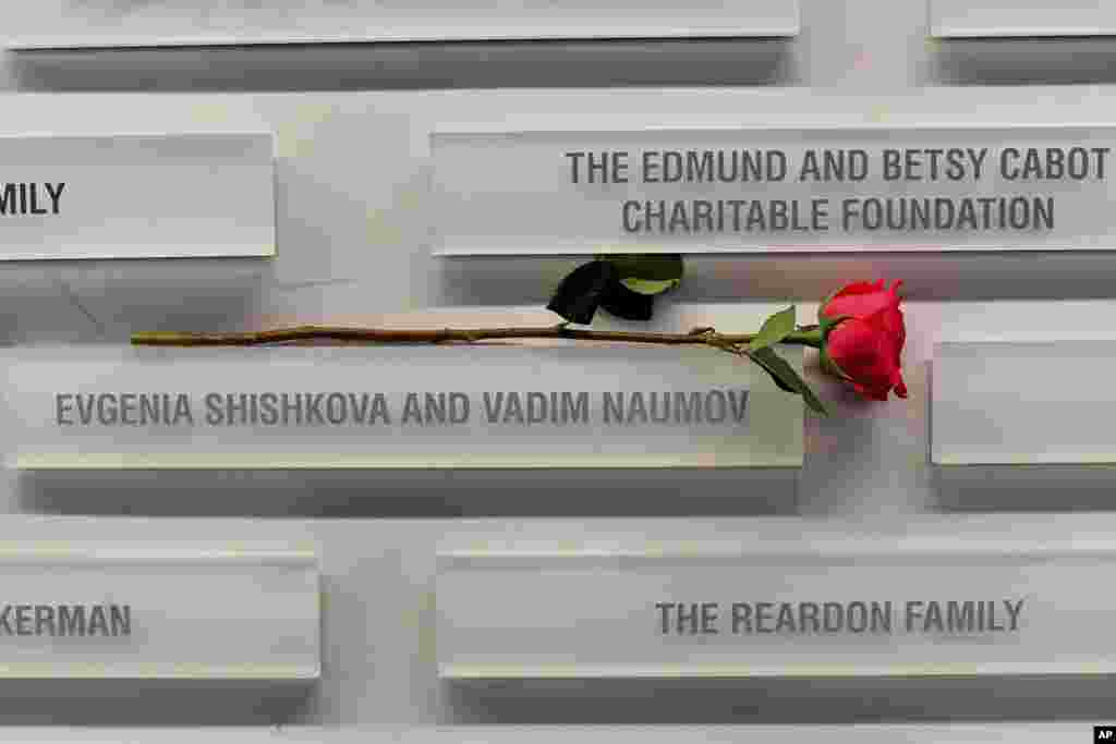 A rose rests near the names of figure skating coaches Evgenia Shishkova and Vadim Naumov on a commemorative wall at the Skating Club of Boston in Norwood, Massachusetts, on January 30. The Russian former world champions were killed in a plane crash in Washington, D.C., the day before.&nbsp;