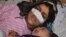 Afghan woman Reza Gul, 20, and whose nose was sliced off by her husband in an attack, lies on a bed with her baby as she receives treatment at a hospital in the northern Afghanistan on January 19. 