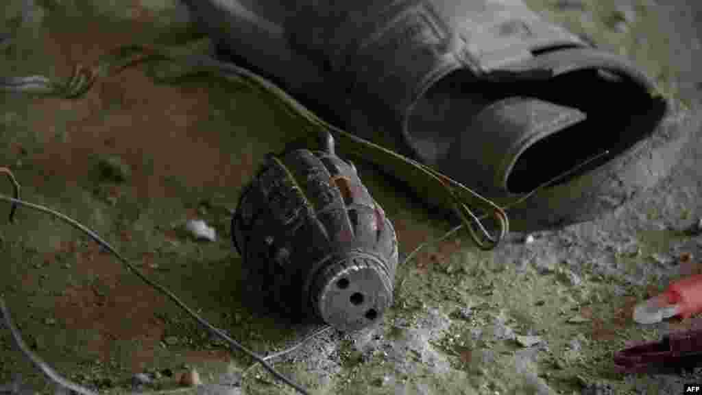 A hand grenade lies on the floor next to a sandal inside a building where militants launched one of the Kabul attacks. (AFP/JOHANNES EISELE)