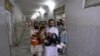 Pakistan -- A man carries a child, who was injured in a suicide bomb attack, to the Lady Reading Hospital for treatment in Peshawar, 21Jun2013