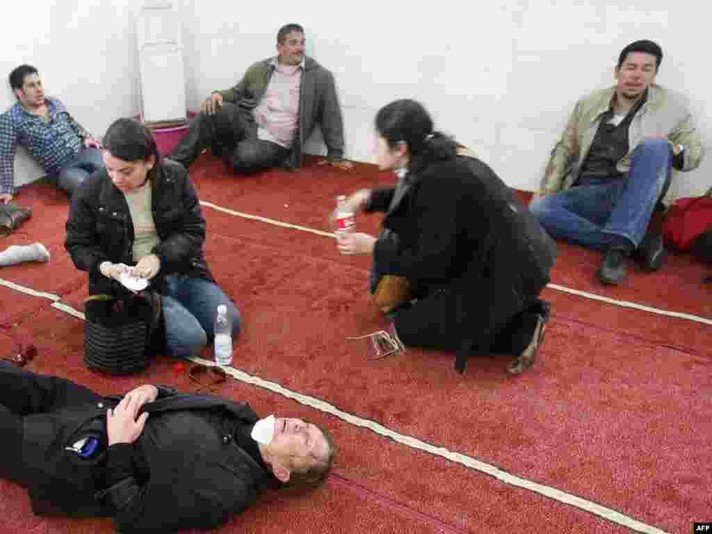 Demonstrators suffering from tear gas hide in a mosque following a demonstration in Cairo on January 28.