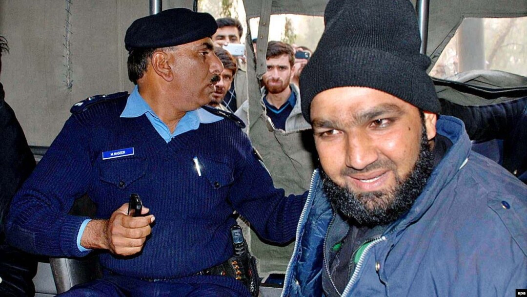 Mumtaz Qadri (right) after his arrest in 2011